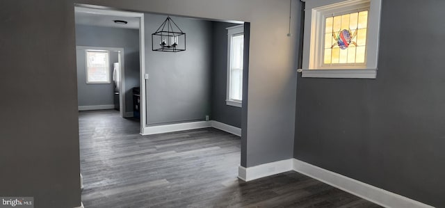 interior space featuring an inviting chandelier and dark hardwood / wood-style floors