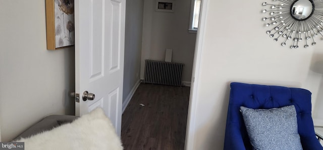 hall featuring radiator heating unit and dark hardwood / wood-style flooring