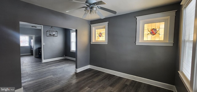 spare room with dark wood-type flooring and ceiling fan