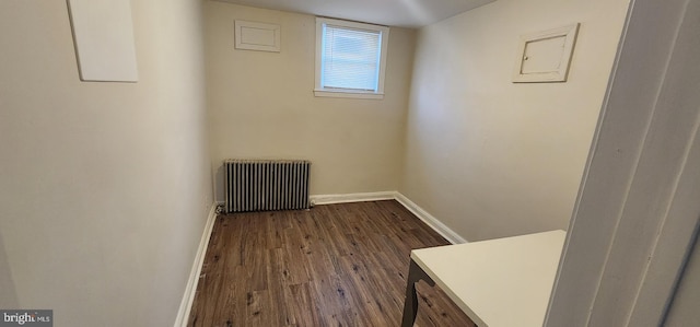 unfurnished room featuring dark hardwood / wood-style flooring and radiator