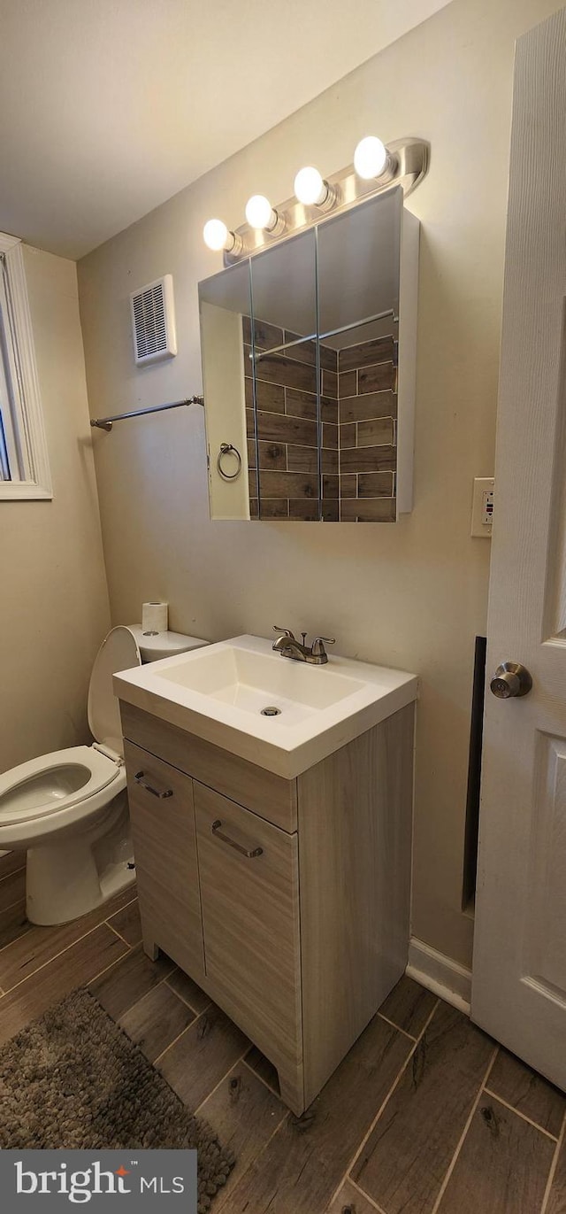 bathroom featuring vanity and toilet