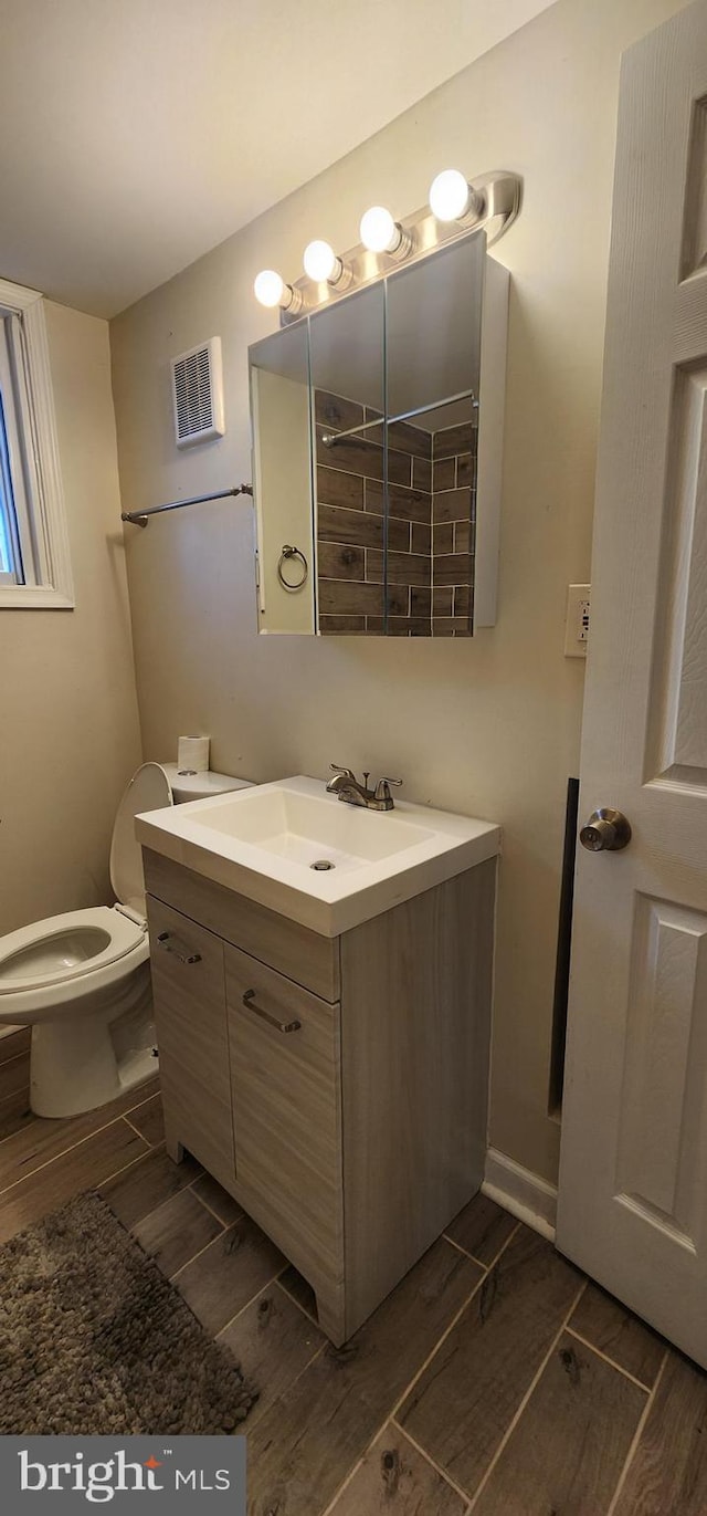 bathroom featuring vanity and toilet