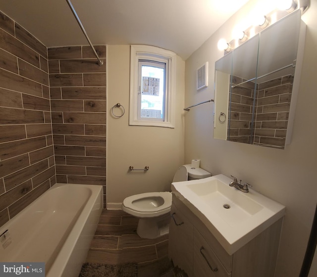 full bathroom with vanity, toilet, and tiled shower / bath combo