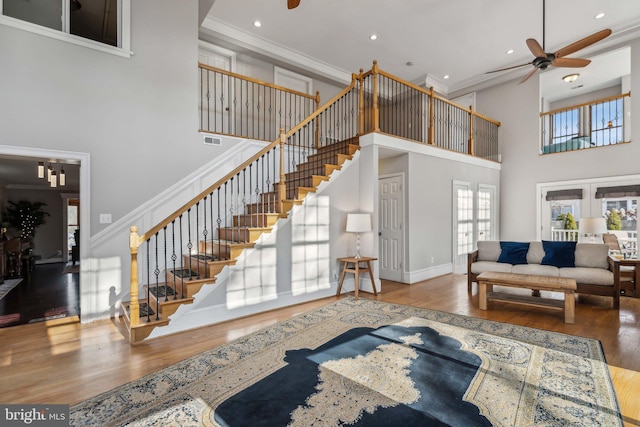 living room with crown molding, hardwood / wood-style flooring, french doors, and ceiling fan