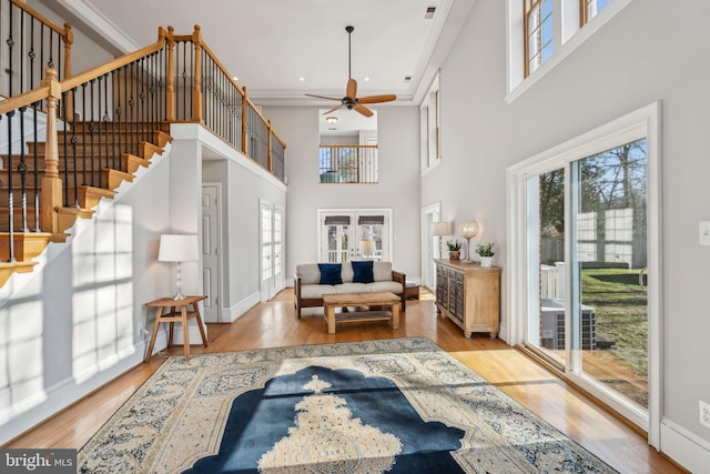 foyer featuring ceiling fan, ornamental molding, light hardwood / wood-style floors, and french doors