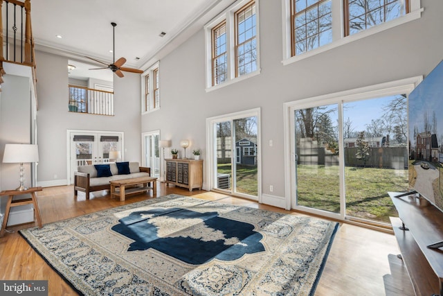 living room featuring hardwood / wood-style floors, french doors, and ceiling fan