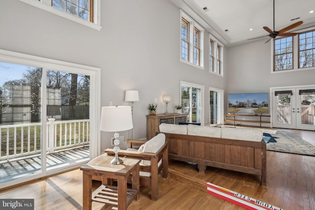 interior space with hardwood / wood-style flooring, french doors, and ceiling fan