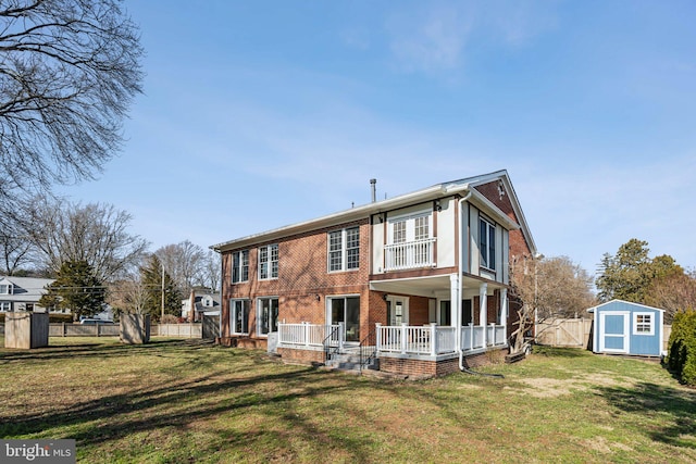 view of front facade featuring a porch, a front lawn, and a storage shed