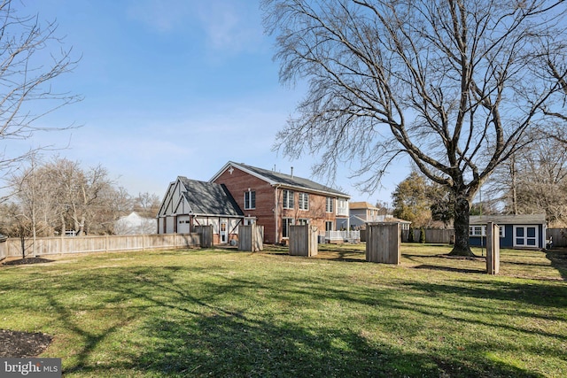 rear view of house with a shed and a lawn