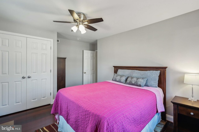 bedroom with dark hardwood / wood-style floors, a closet, and ceiling fan