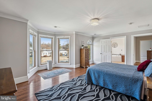 bedroom with ornamental molding, dark hardwood / wood-style floors, and connected bathroom