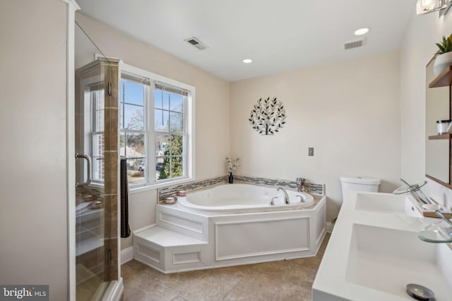 full bathroom featuring toilet, vanity, and shower with separate bathtub