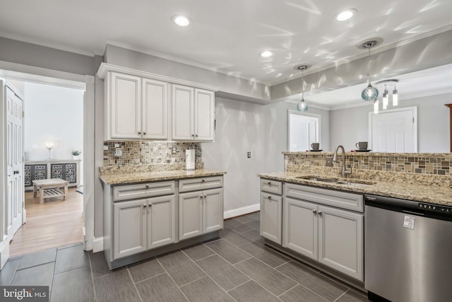 kitchen with decorative light fixtures, sink, white cabinets, stainless steel dishwasher, and light stone counters