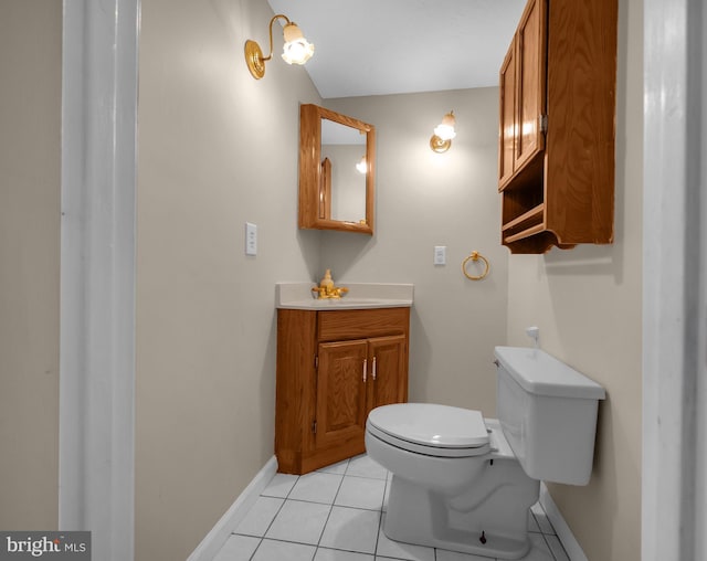 bathroom with tile patterned flooring, vanity, and toilet