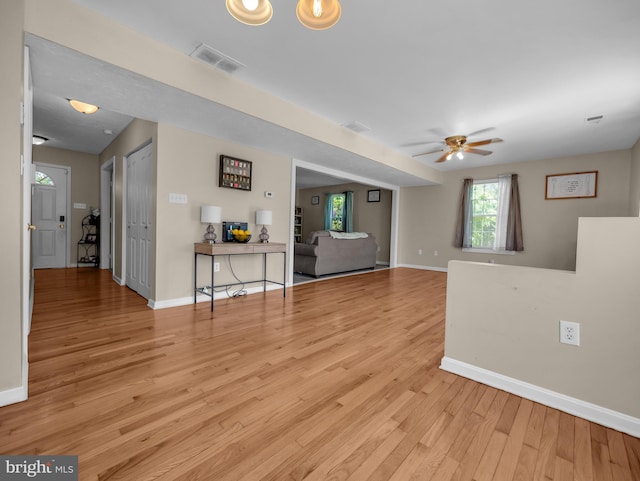 unfurnished living room with ceiling fan and light hardwood / wood-style floors