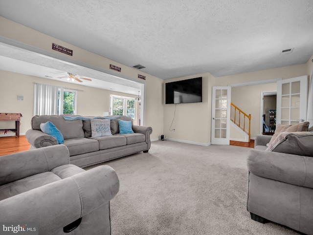 living room with light carpet and a textured ceiling