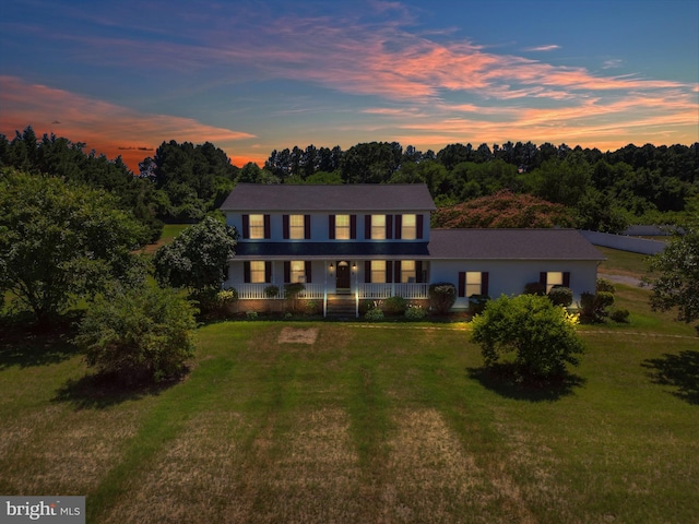 view of front of home featuring a lawn and a porch