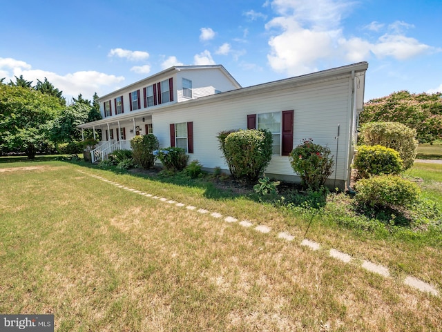 view of front of property with covered porch and a front lawn