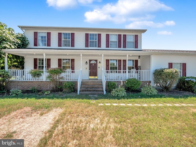 view of front facade featuring covered porch and a front lawn