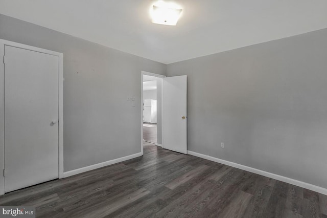 spare room featuring dark wood-type flooring