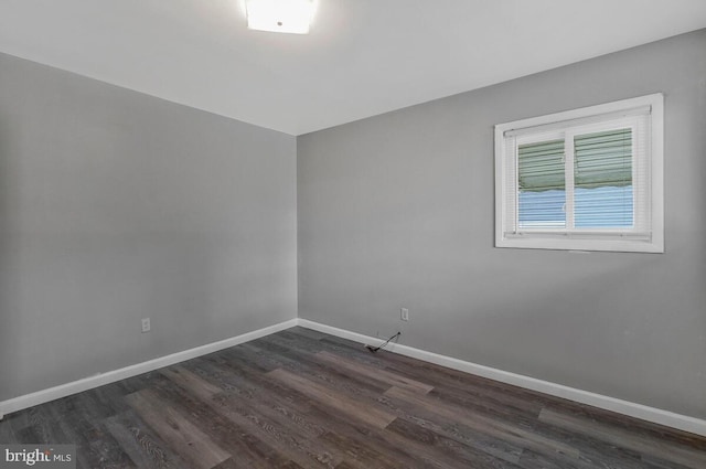 empty room with dark hardwood / wood-style floors