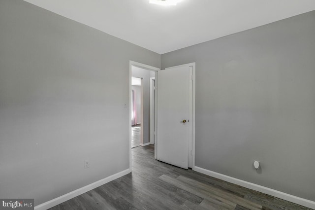 empty room featuring dark wood-type flooring