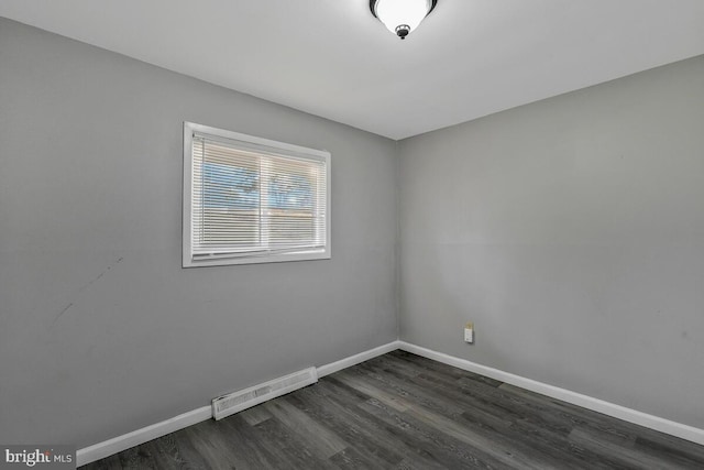 spare room with dark hardwood / wood-style flooring