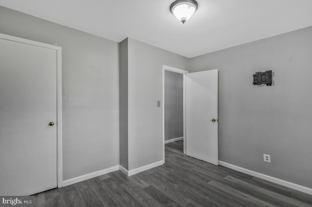 unfurnished bedroom featuring dark hardwood / wood-style flooring