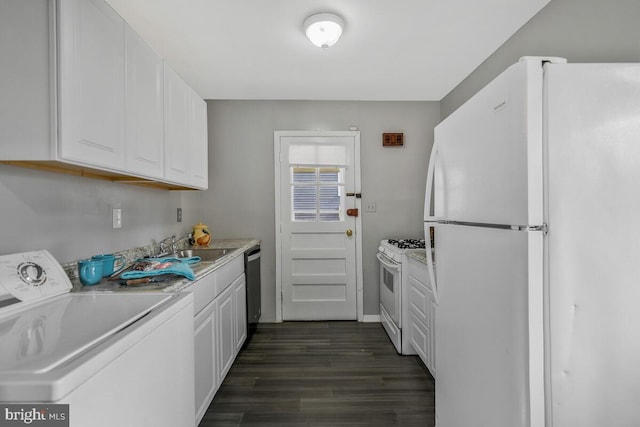 kitchen with sink, white appliances, dark hardwood / wood-style floors, white cabinets, and washer / dryer