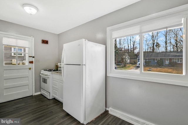 kitchen featuring dark wood-type flooring, white appliances, and white cabinets