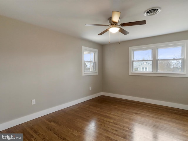 spare room featuring hardwood / wood-style floors and ceiling fan