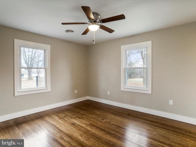 spare room featuring ceiling fan and dark hardwood / wood-style floors