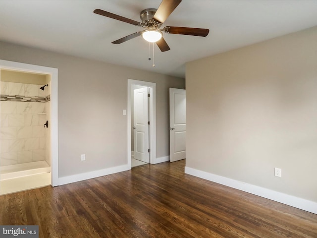 unfurnished bedroom with ceiling fan, dark wood-type flooring, and ensuite bath