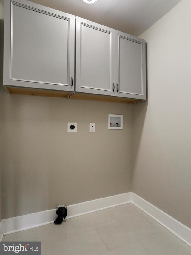 laundry area featuring cabinets, washer hookup, hookup for an electric dryer, and light tile patterned floors