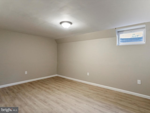 interior space featuring lofted ceiling and light hardwood / wood-style floors