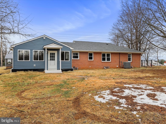 back of house featuring a yard and central AC