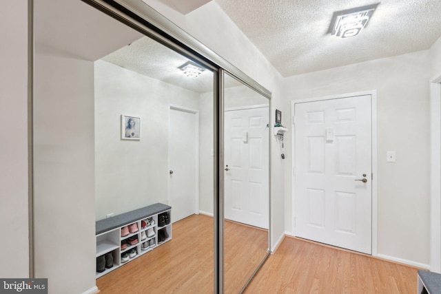 entrance foyer with hardwood / wood-style flooring and a textured ceiling