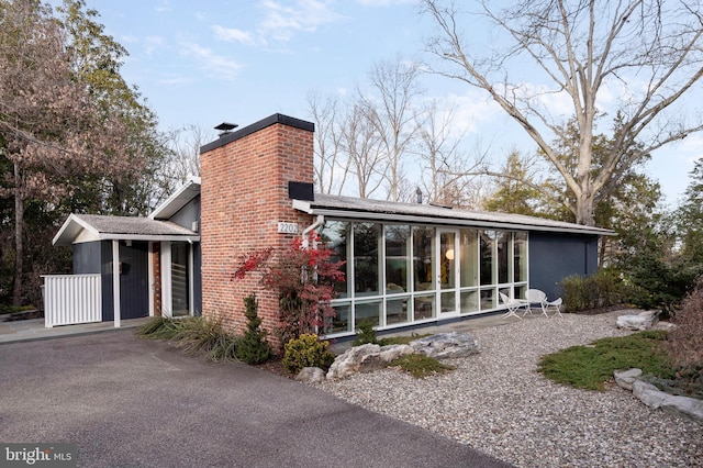 view of side of home featuring a sunroom