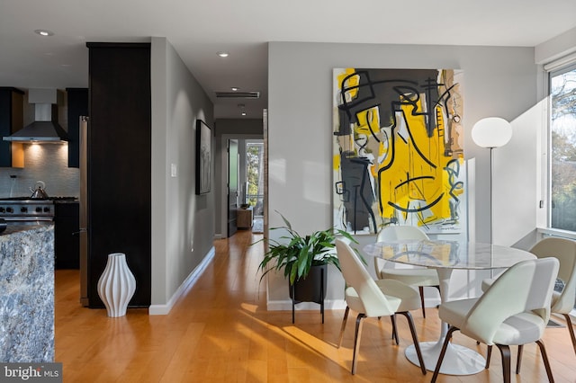 dining space featuring light hardwood / wood-style floors and a healthy amount of sunlight