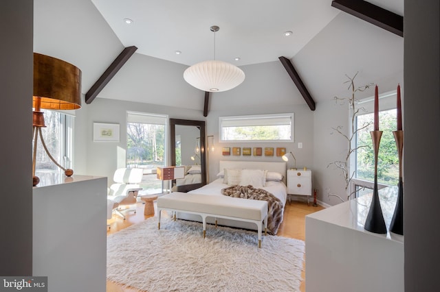 bedroom with multiple windows, light hardwood / wood-style flooring, and lofted ceiling with beams