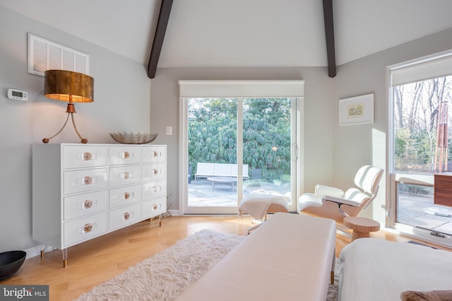 bedroom featuring lofted ceiling with beams, access to outside, and light hardwood / wood-style flooring