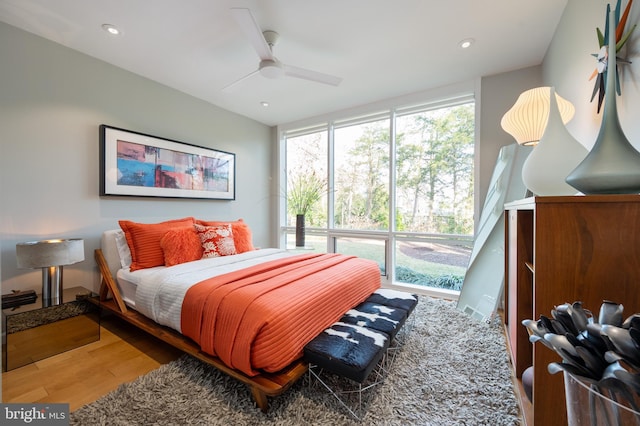 bedroom with hardwood / wood-style floors and ceiling fan