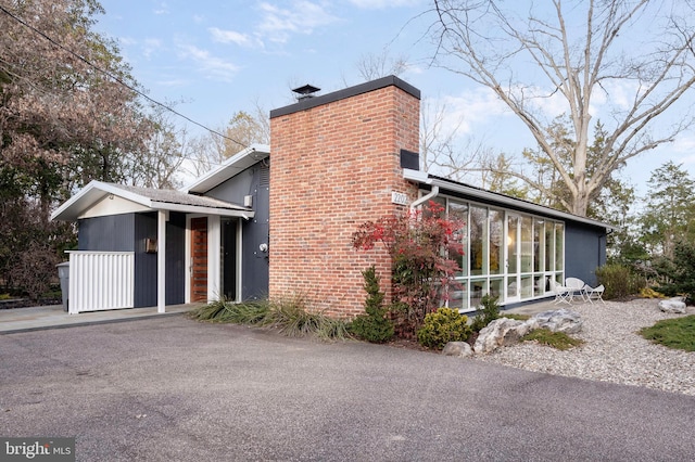 view of side of property with a sunroom