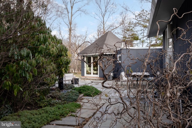 view of side of property with a patio area