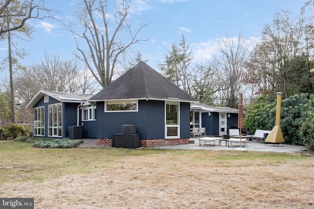 back of house featuring a sunroom, a yard, central AC, and a patio area