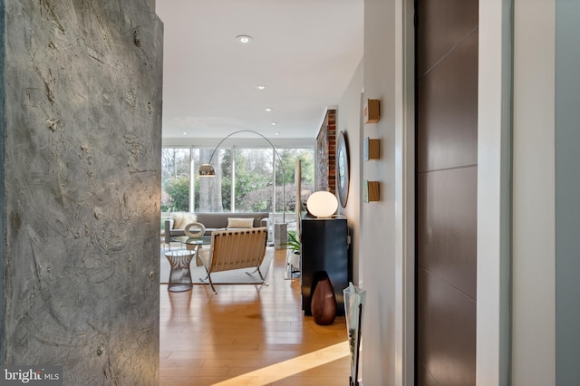 corridor featuring expansive windows and light hardwood / wood-style flooring