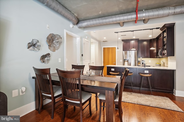 dining room featuring dark hardwood / wood-style floors and sink