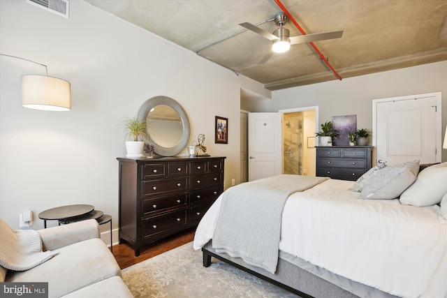 bedroom with ensuite bath and light wood-type flooring