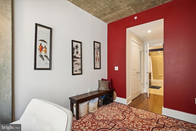 bedroom featuring hardwood / wood-style flooring and connected bathroom