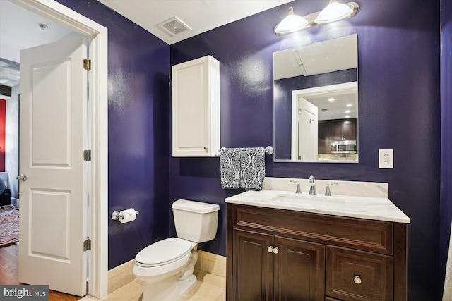 bathroom with vanity and toilet